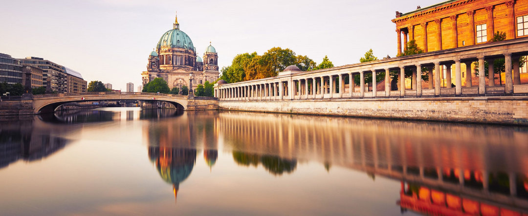 View of the Spree river passing through Berlin with the cathedral in the background.